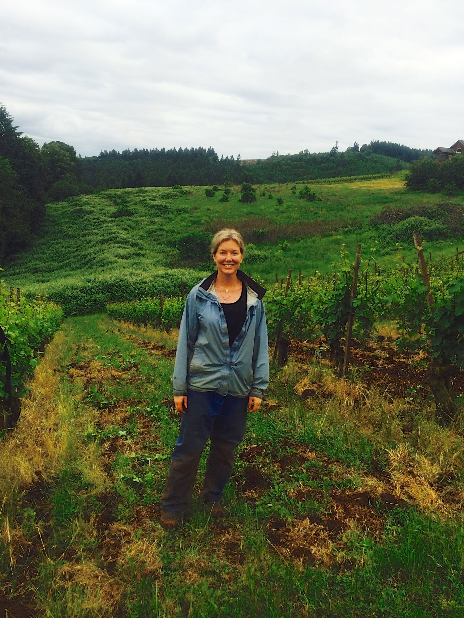 Kelley Fox standing in the Maresh Vineyard in Oregon Willamette Valley